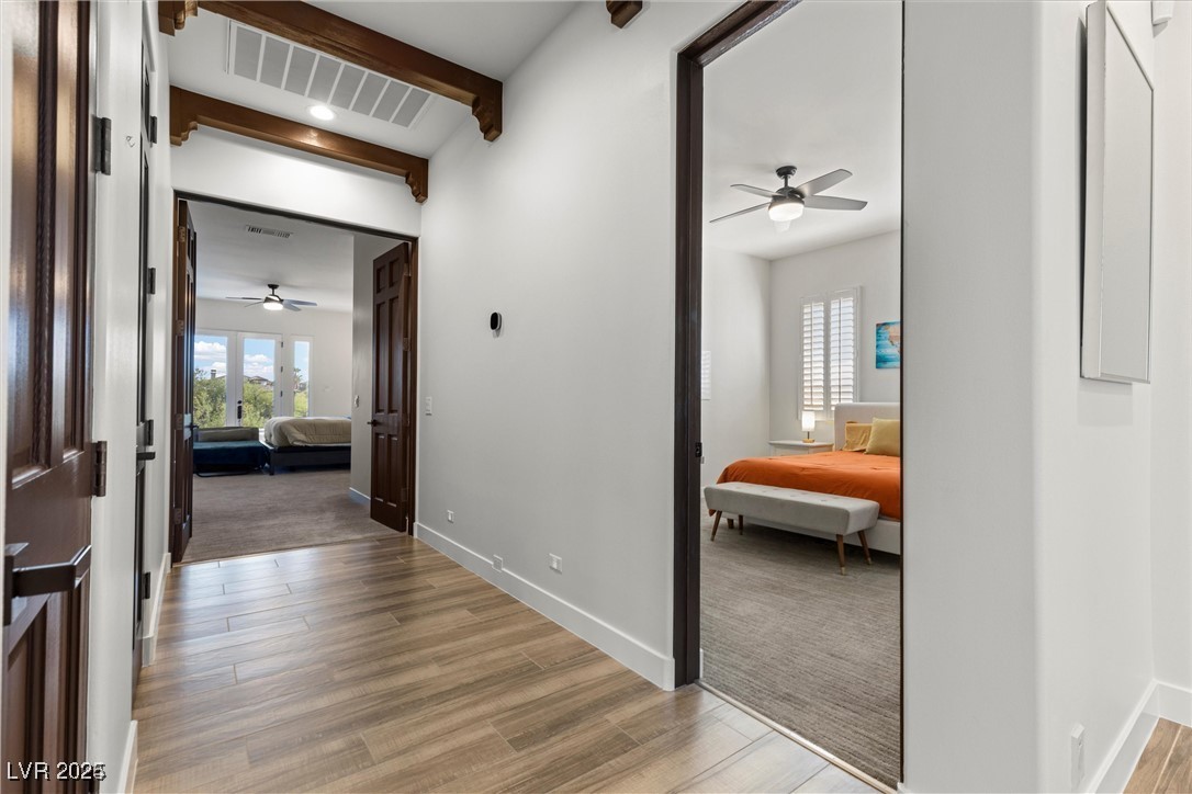 3 Rue Allard Way Henderson, NV 89011 - Photo 20 of 49 Corridor featuring beam ceiling, visible vents, baseboards, and light wood finished floors