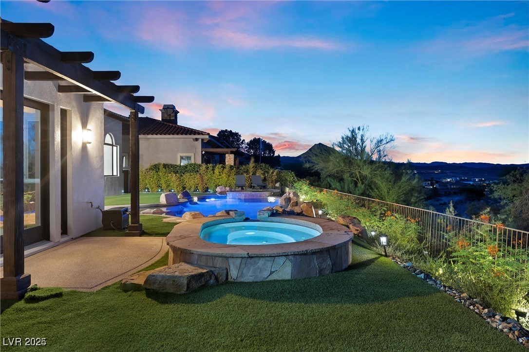 3 Rue Allard Way Henderson, NV 89011 - Photo 2 of 49 Pool at dusk featuring an in ground hot tub, a yard, fence, and a fenced in pool