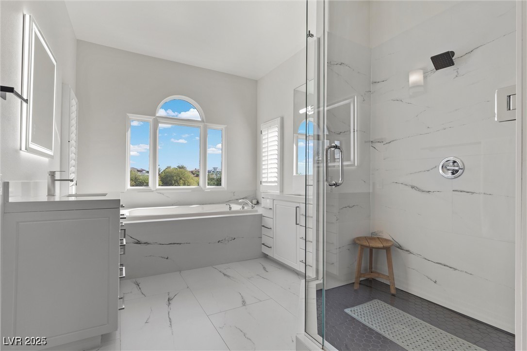 3 Rue Allard Way Henderson, NV 89011 - Photo 23 of 49 Bathroom with marble finish floor, a marble finish shower, a bath, and vanity