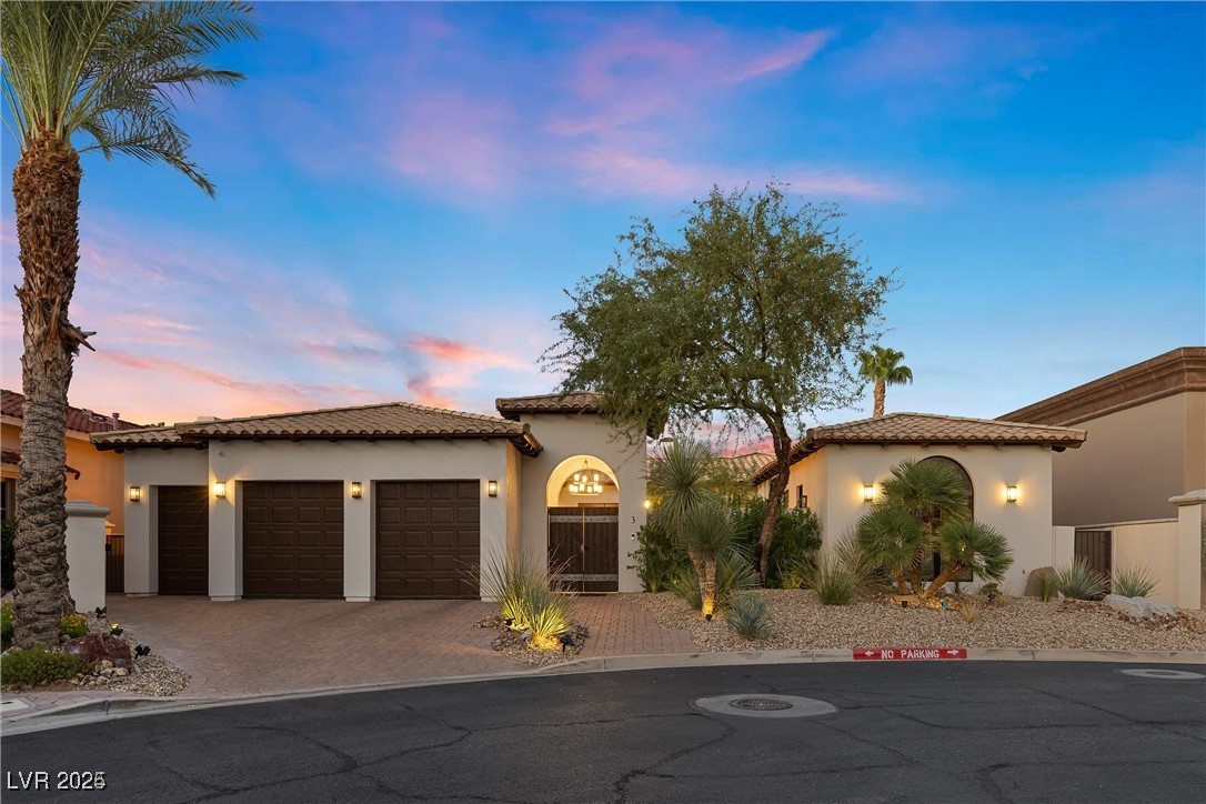 3 Rue Allard Way Henderson, NV 89011 - Photo 4 of 49 Mediterranean / spanish-style home featuring an attached garage, a tiled roof, decorative driveway, and stucco siding