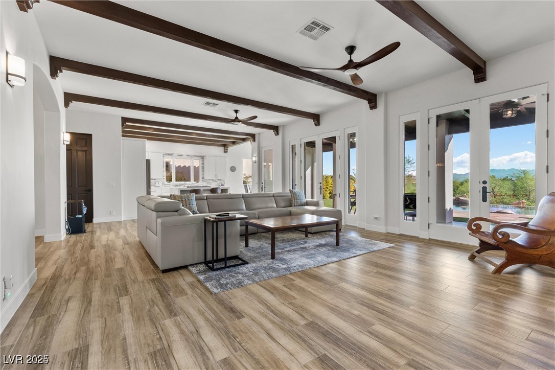 3 Rue Allard Way Henderson, NV 89011 - Photo 7 of 49 Living area featuring a wealth of natural light, french doors, visible vents, and a ceiling fan