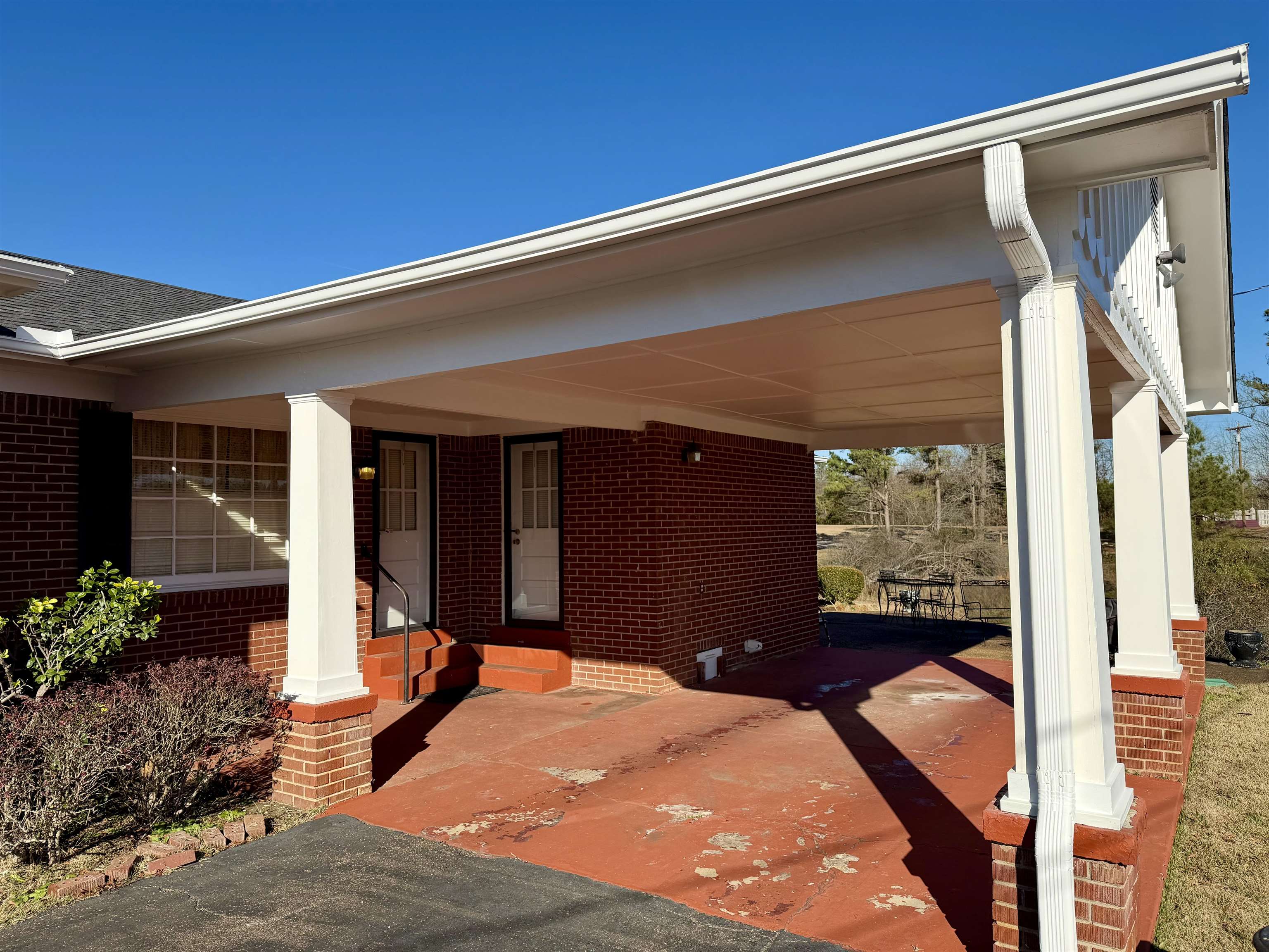 192 New Bethel Road Selmer, TN 38375 - Photo 25 of 27 Covered porch with an attached carport and driveway