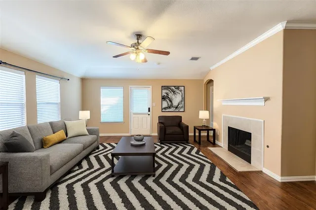 a living room with furniture a fireplace and a window