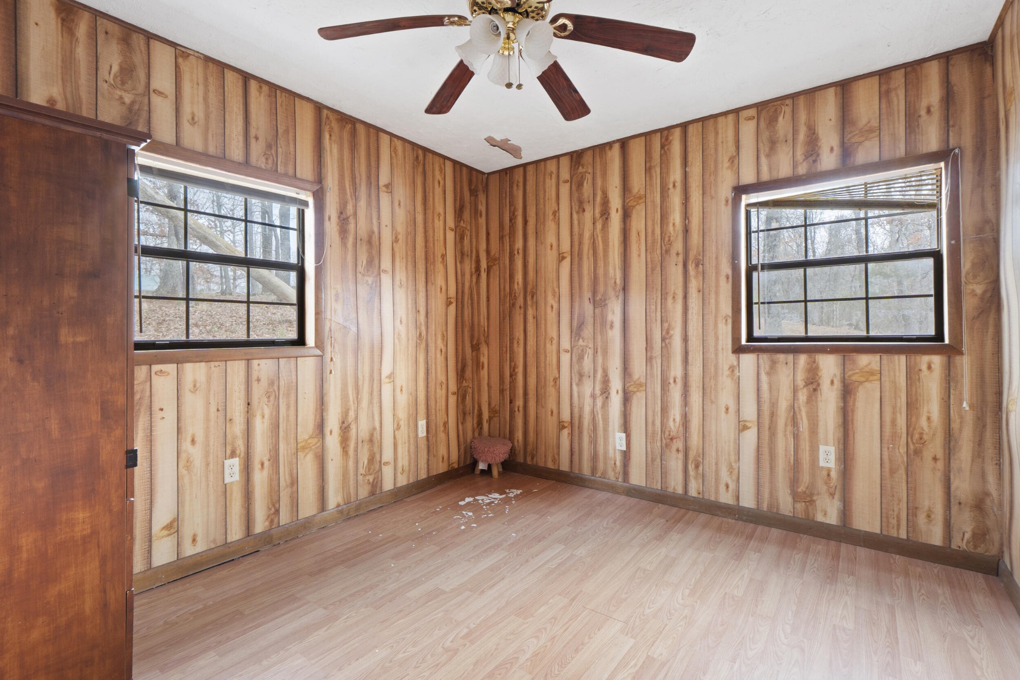 1475 Patton School Road South Pittsburg, TN 37380 - Photo 11 of 22 an empty room with wooden floor chandelier fan and windows