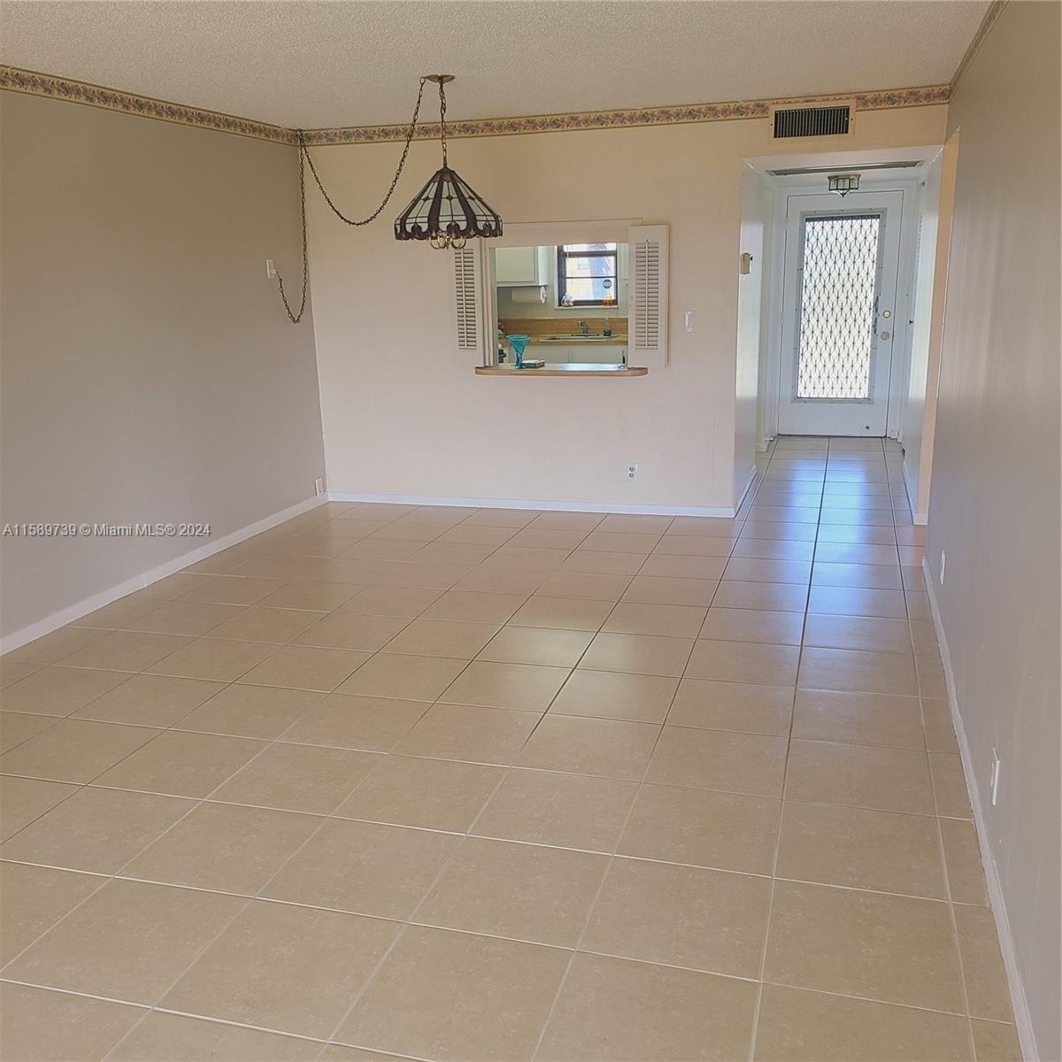 9233 Southwest 8th Street, Unit 201 Boca Raton, FL 33428 - Photo 5 of 30 a view of a hallway with wooden floor and a window