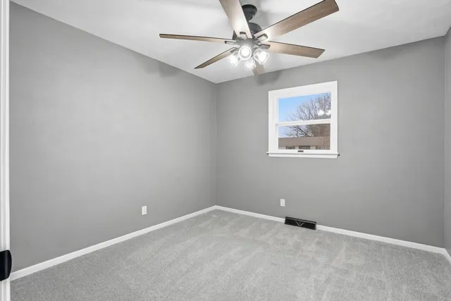 an empty room with a fan