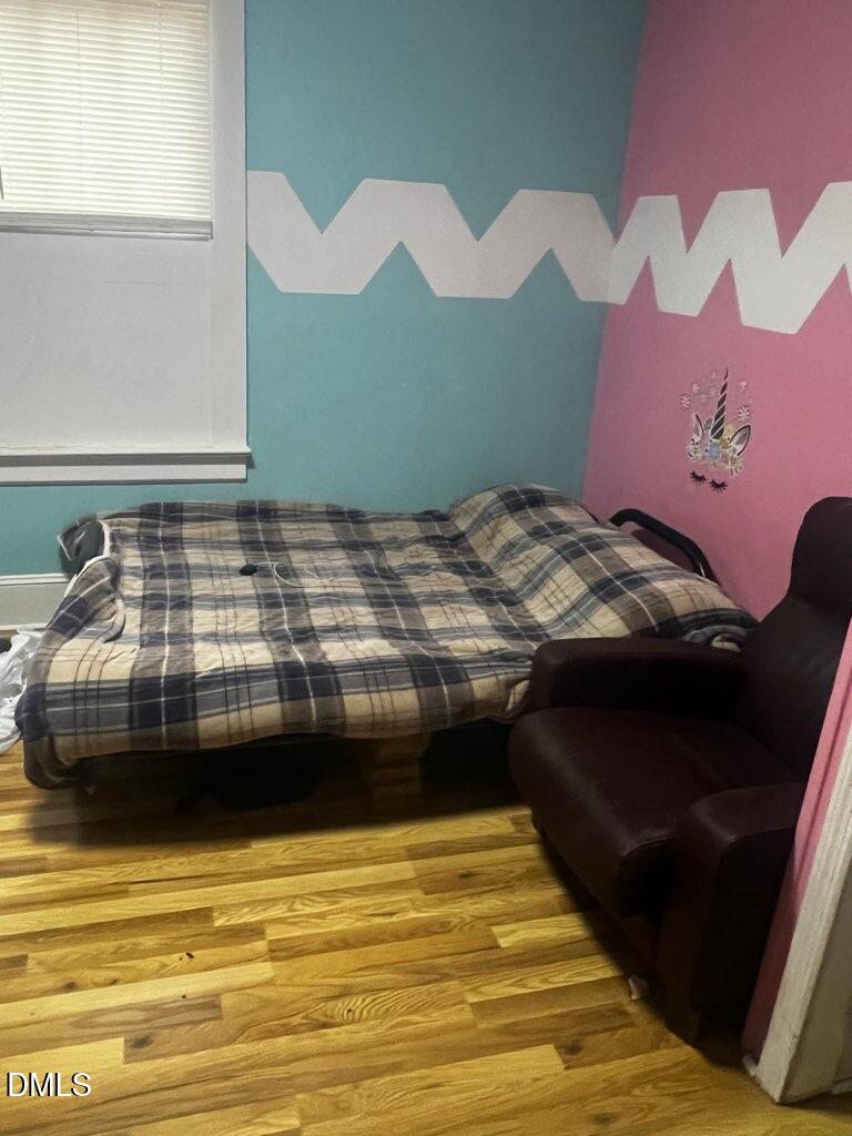 217 Heck Street Raleigh, NC 27601 - Photo 12 of 22 a bedroom with a bed and window