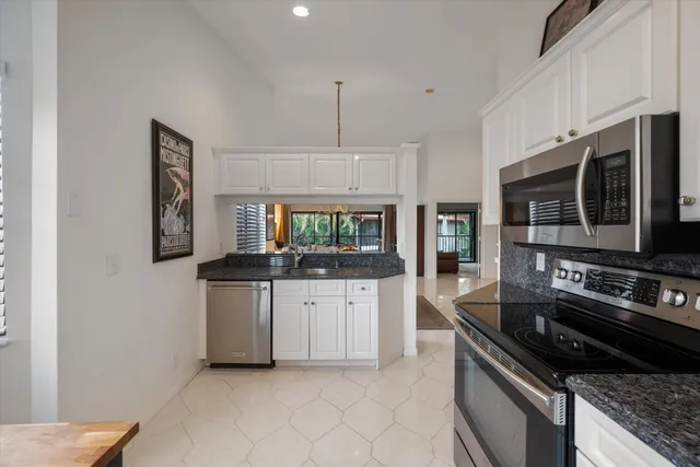 a bedroom with a bed and a dresser with mirror
