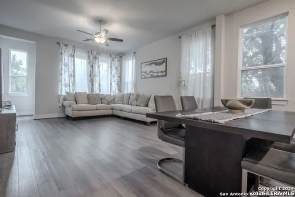 a living room with furniture and large windows