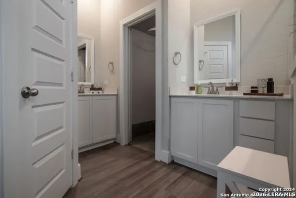 a bathroom with a sink a toilet and mirror