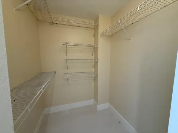 en empty room with windows and yard