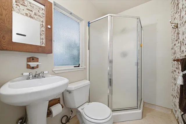 a bathroom with a sink toilet and mirror