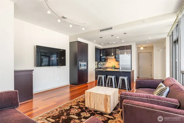 a living room with furniture and kitchen view
