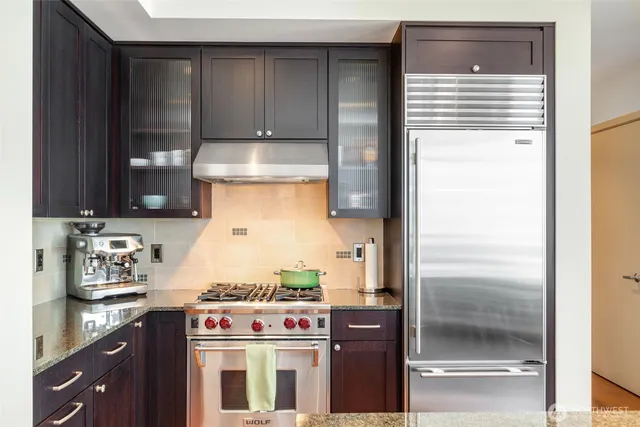 a kitchen with a refrigerator and a stove