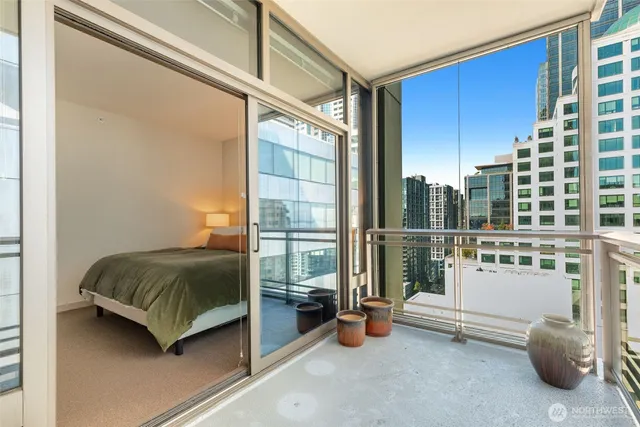 a bedroom with a bed and glass door
