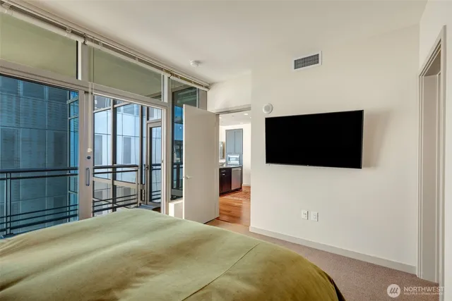 a bedroom with a bed and a flat screen tv