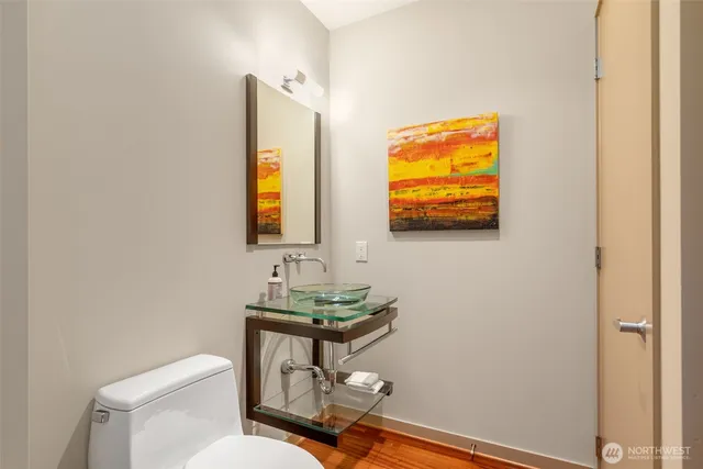 a bathroom with a toilet a sink and mirror