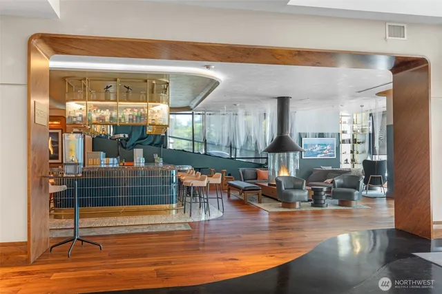 a view of a dining hall with floor to ceiling windows and wooden floor