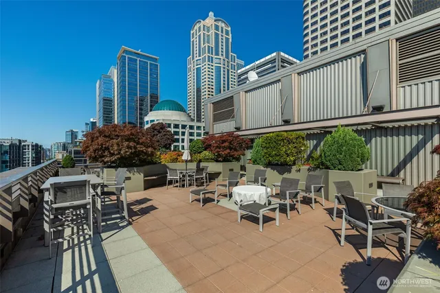 a view of a patio with couches table and chairs and potted plants