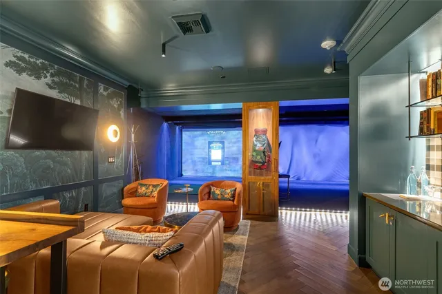 a room with furniture projector and screen