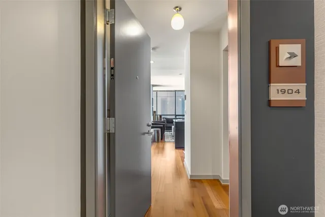 a view of a hallway with wooden floor