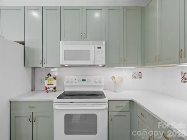 a kitchen with a sink cabinets and appliances