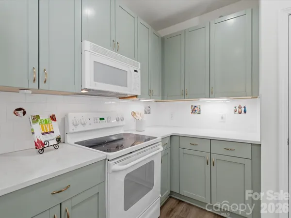 a kitchen with a sink cabinets and appliances