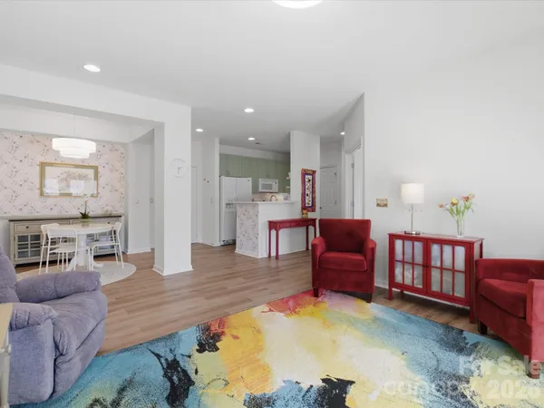 a living room with furniture and kitchen view