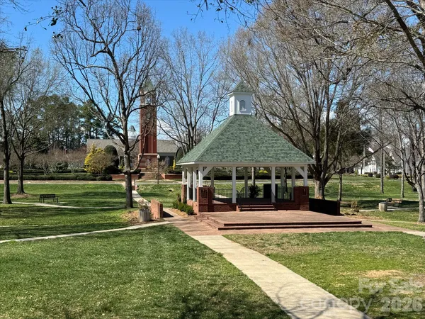 a front view of a building with a garden