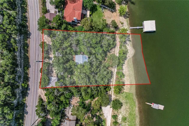 an aerial view of residential house with outdoor space and trees around