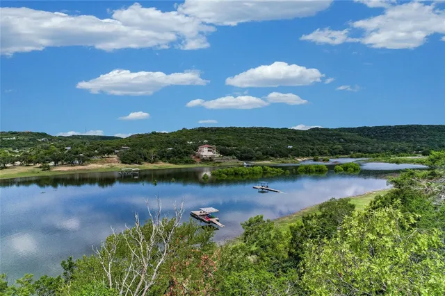 an aerial view of a houses with a lake view