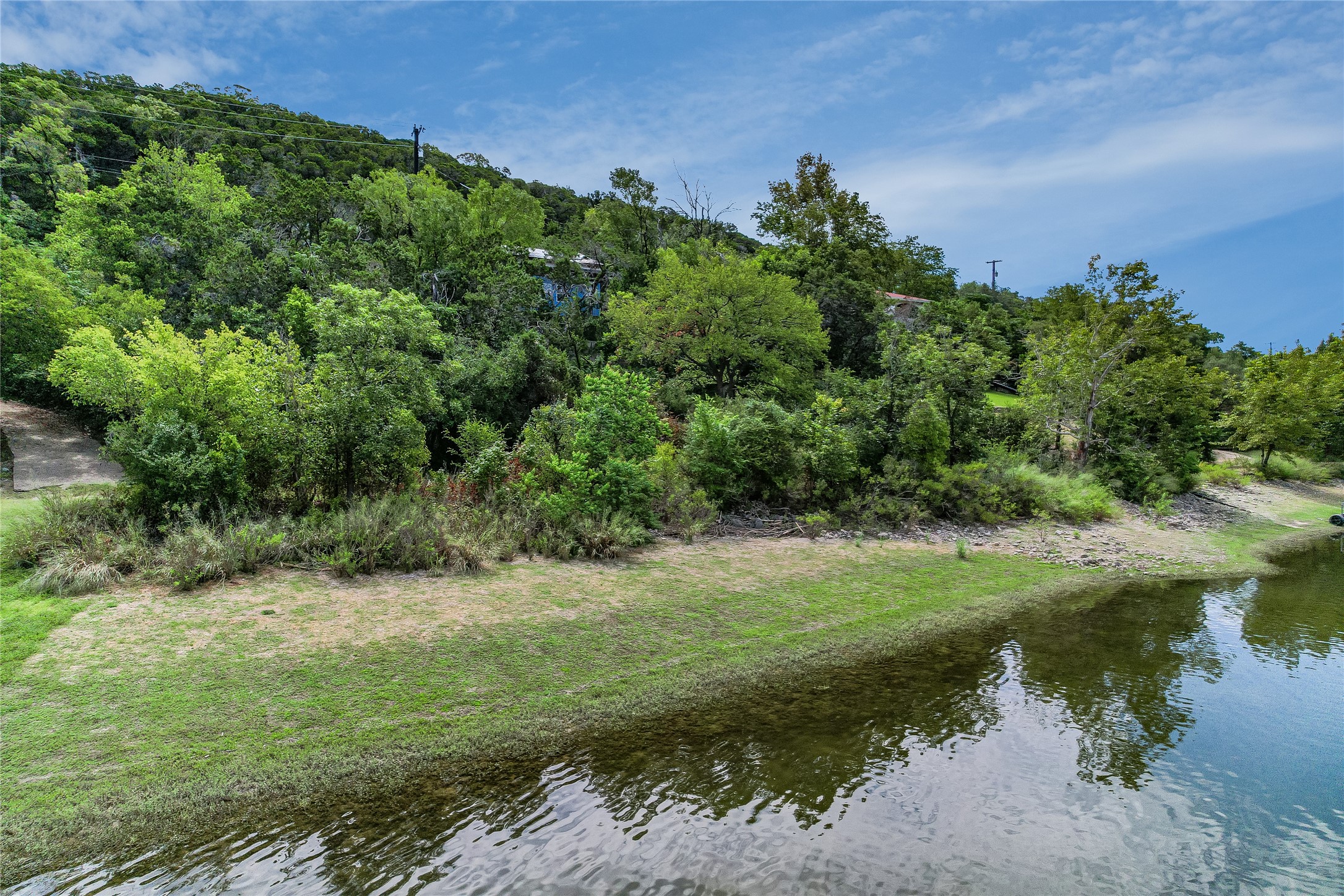 13527 Bullick Hollow Road Austin, TX 78726 - Photo 8 of 11 a view of a lake with a building in the background