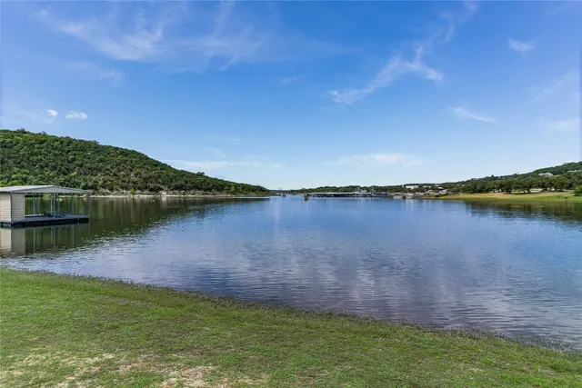 a view of a lake with houses in the background