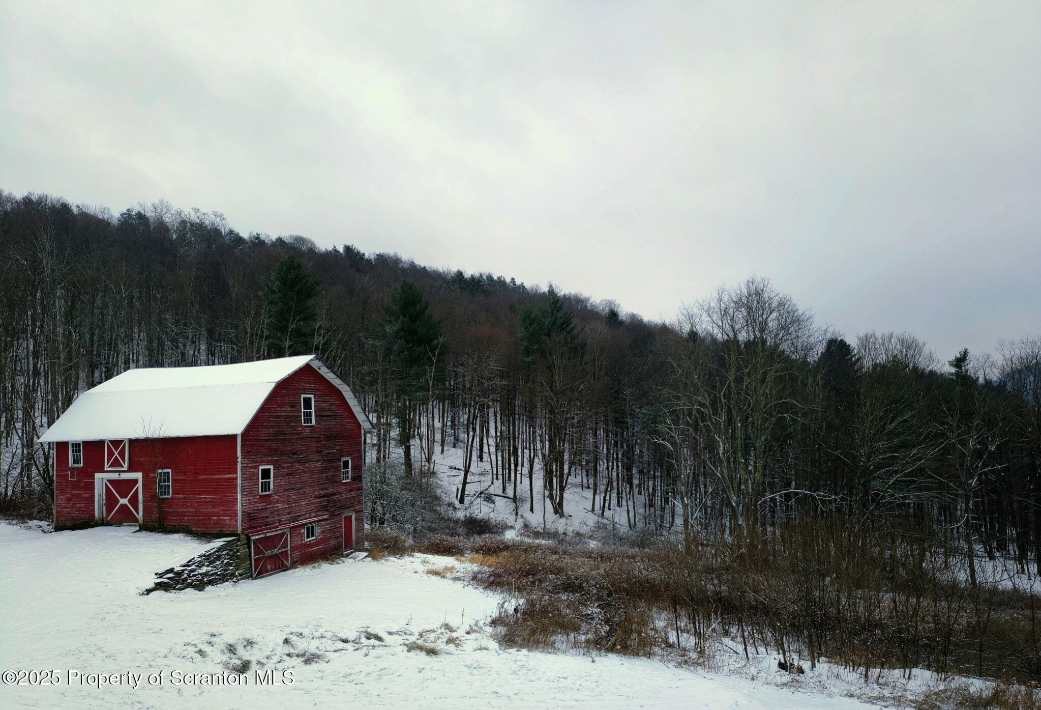 a view of a big house with a big yard and large trees