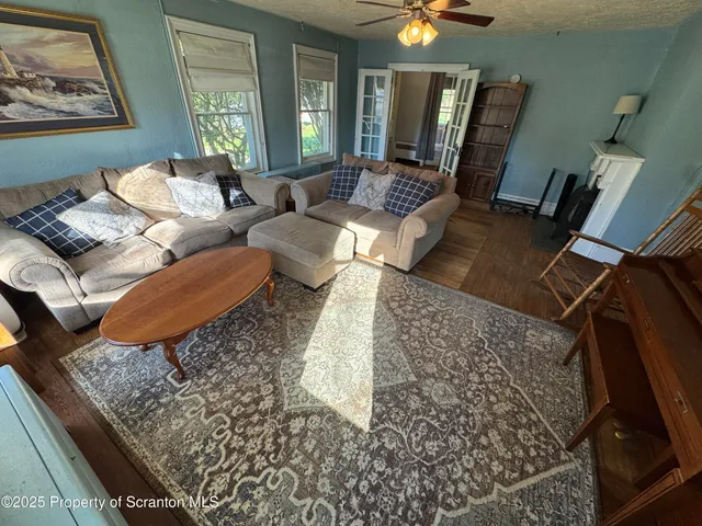 a living room with furniture and a wooden floor