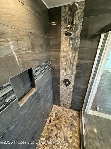 a bathroom with a glass shower door