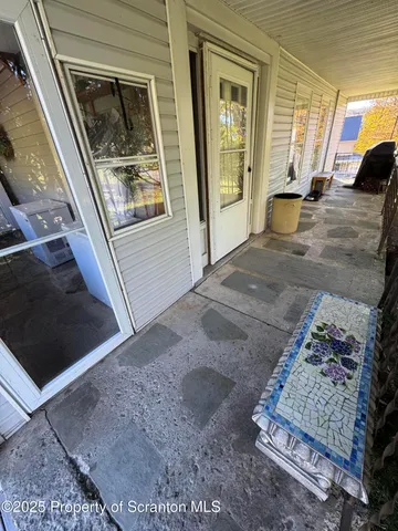 a kitchen with stainless steel appliances wooden floor and chair