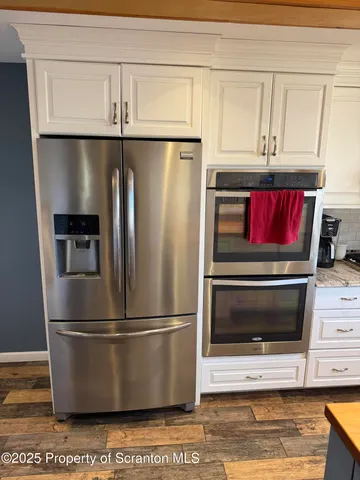 a bedroom with furniture and large windows
