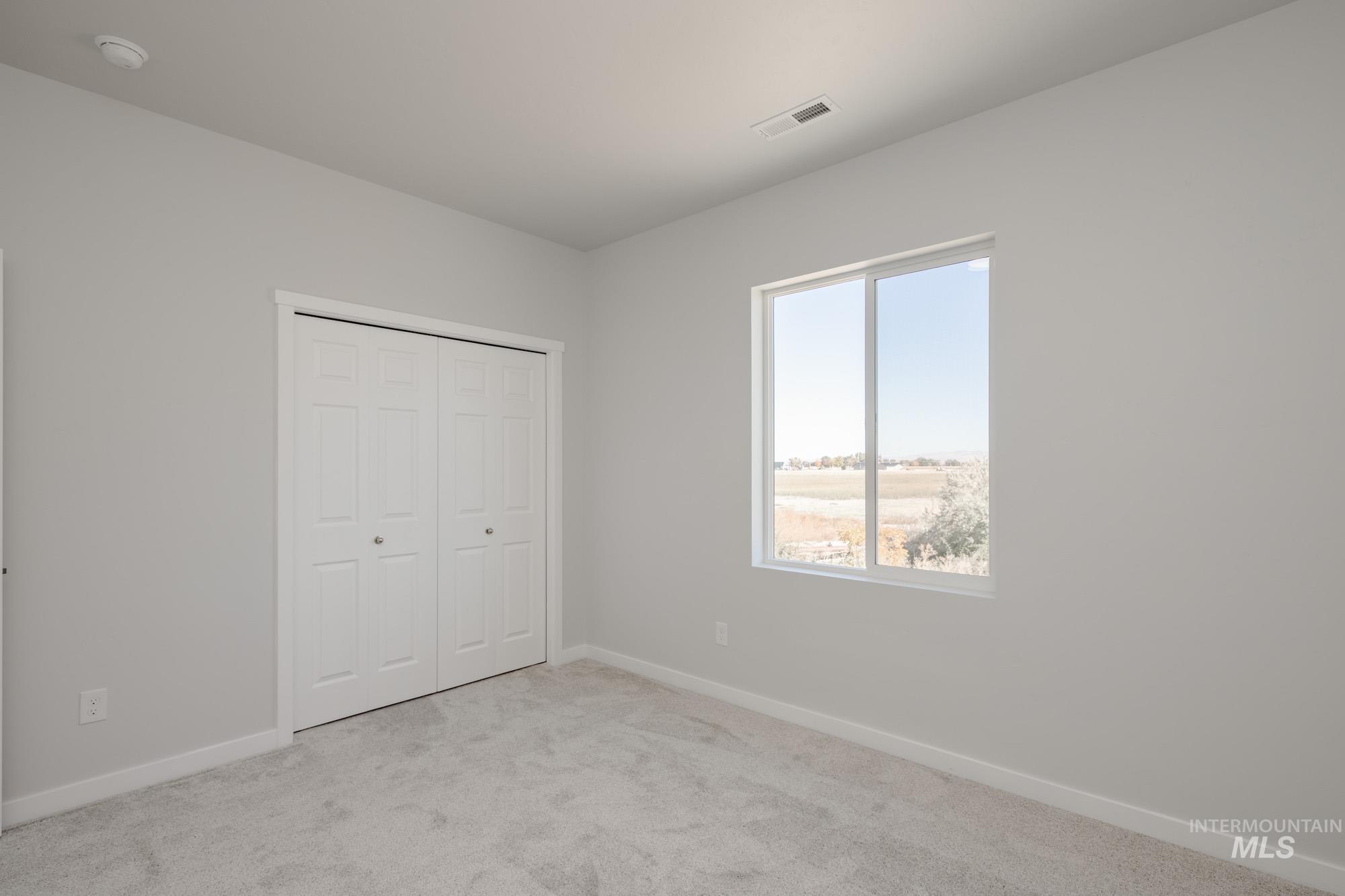 3170 South Maple Rnch Way Nampa, ID 83686 - Photo 23 of 32 Unfurnished bedroom with carpet floors and a closet