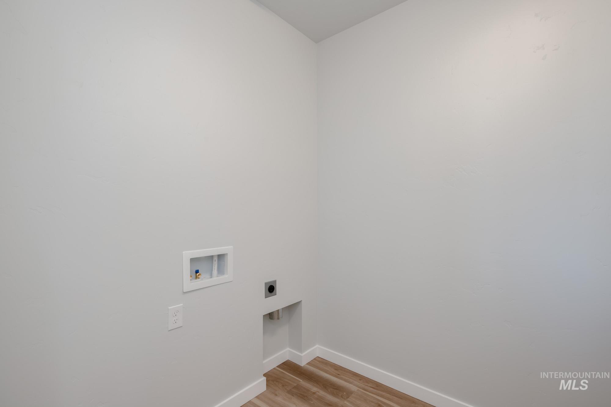 3170 South Maple Rnch Way Nampa, ID 83686 - Photo 24 of 32 Laundry room featuring light wood-type flooring, hookup for a washing machine, and hookup for an electric dryer