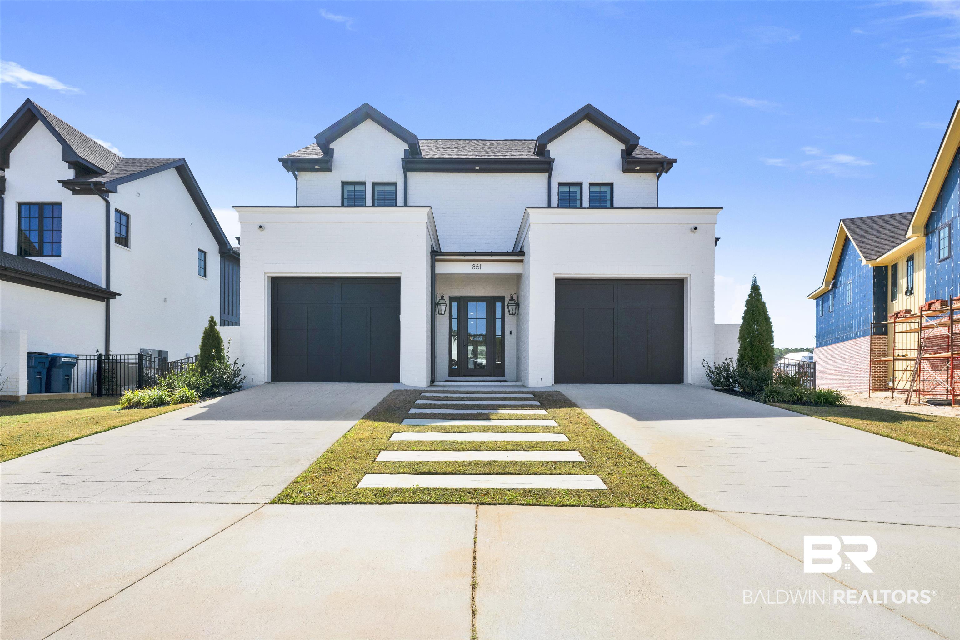 861 Inlet Circle Gulf Shores, AL 36542 - Photo 38 of 54 View of front facade with concrete driveway, stucco siding, and an attached garage
