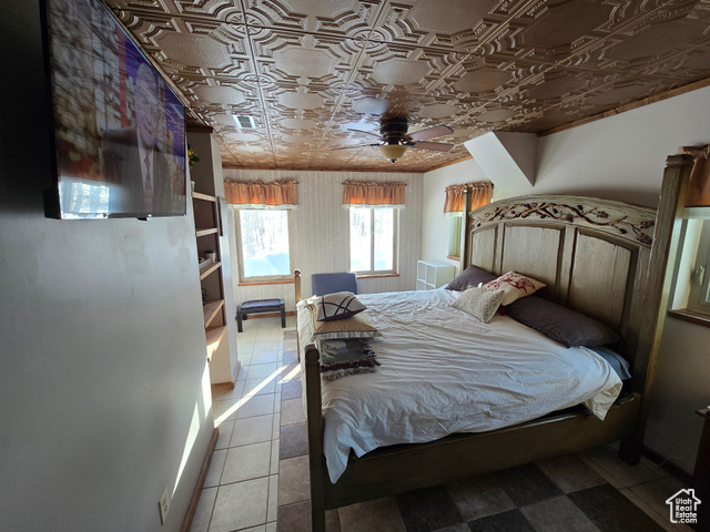 2029 West Tollgate Road Coalville, UT 84017 - Photo 32 of 43 Bedroom featuring an ornate ceiling, tile patterned flooring, and a ceiling fan