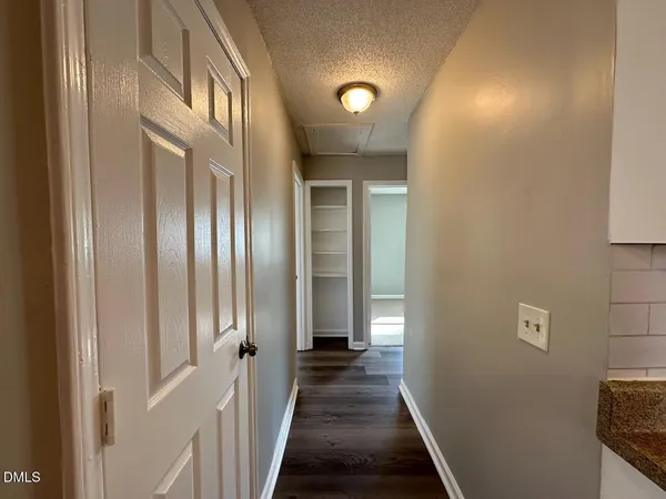 a view of a livingroom and a hallway