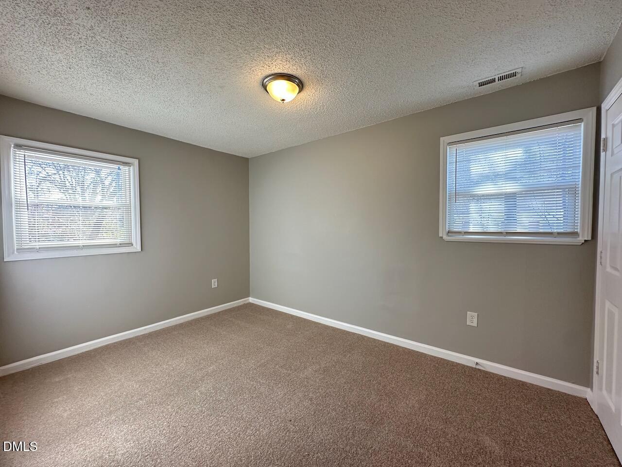1128 Savannah Drive Raleigh, NC 27610 - Photo 16 of 21 an empty room with windows