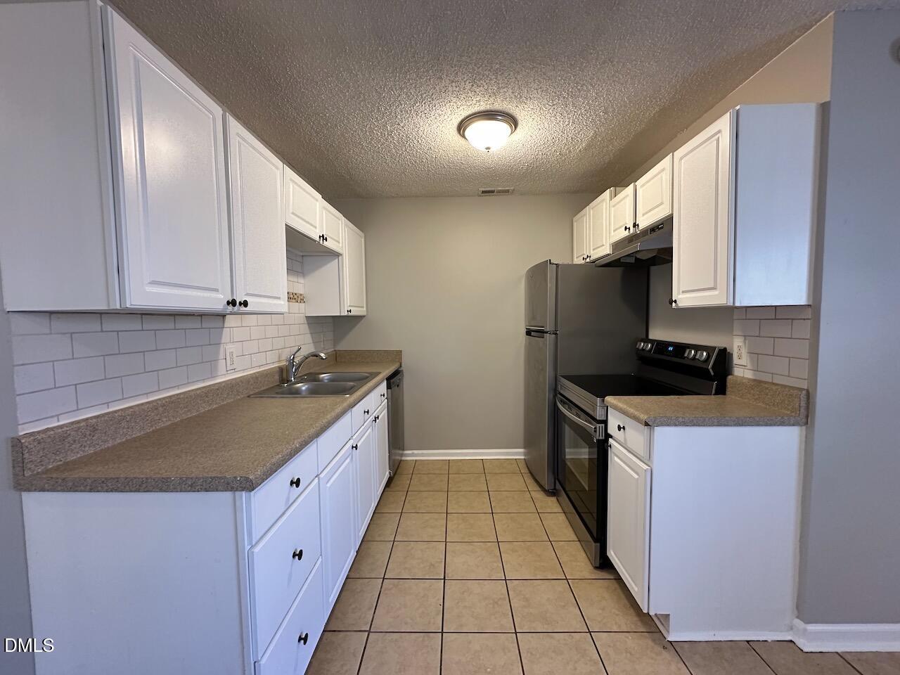 1128 Savannah Drive Raleigh, NC 27610 - Photo 4 of 21 a kitchen with stainless steel appliances granite countertop a sink stove and refrigerator