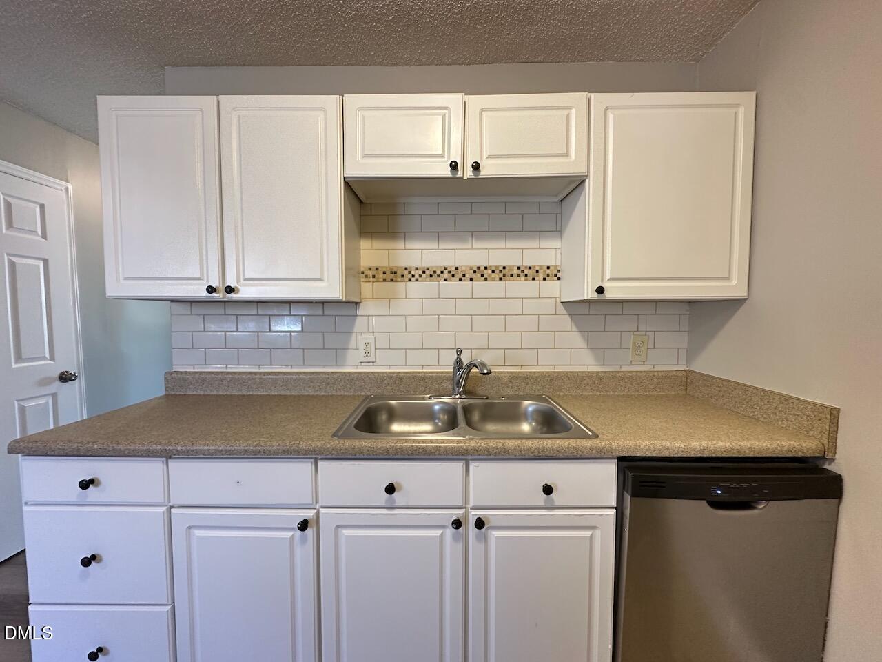 1128 Savannah Drive Raleigh, NC 27610 - Photo 5 of 21 a kitchen with a sink and cabinets