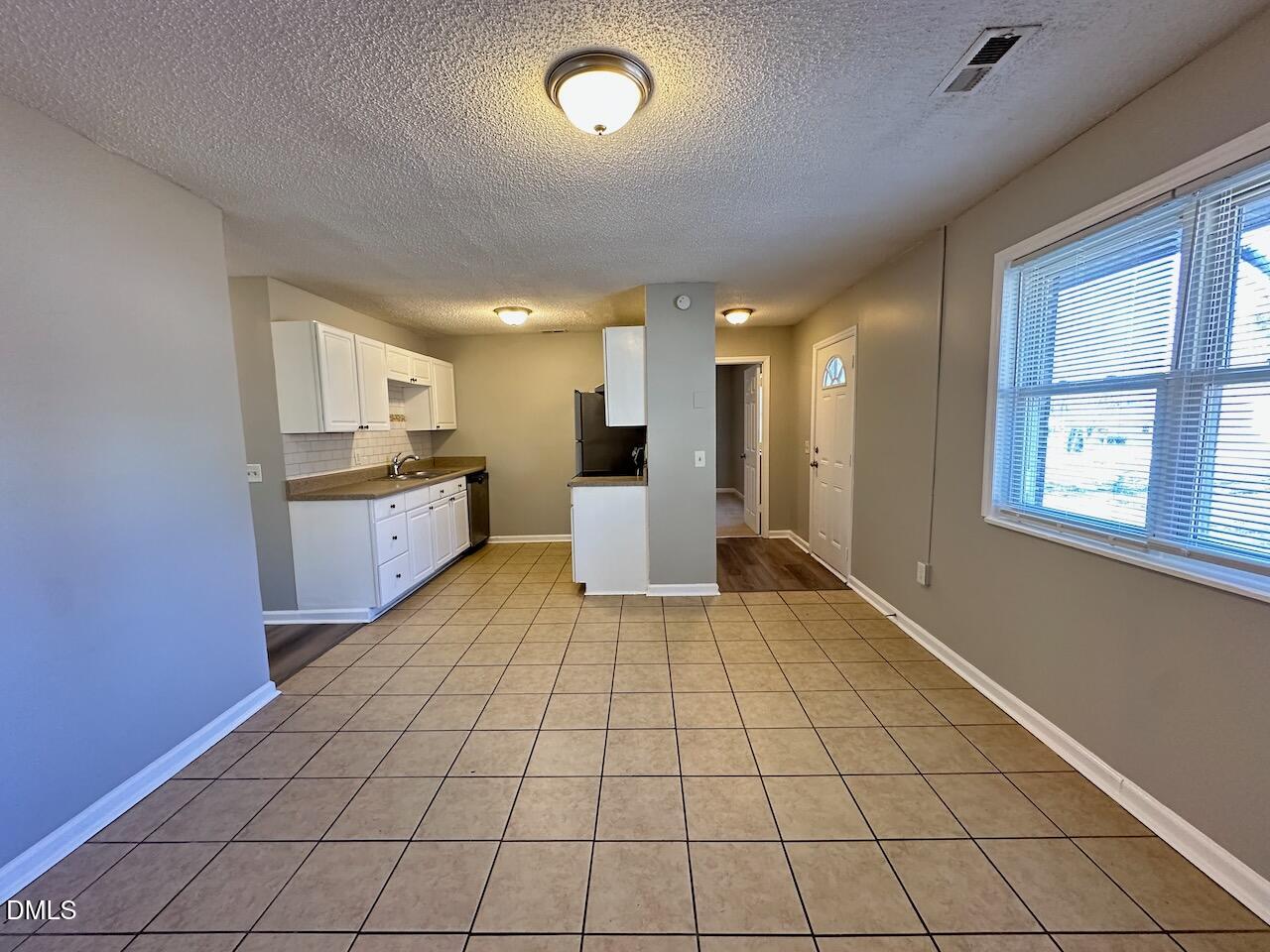 1128 Savannah Drive Raleigh, NC 27610 - Photo 8 of 21 a large white kitchen with a stove a sink dishwasher and a refrigerator