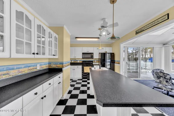 a kitchen with stainless steel appliances granite countertop a sink and a counter top space