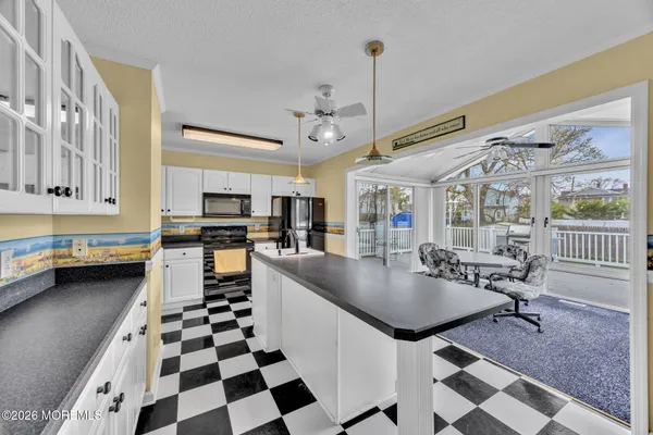 a kitchen with stainless steel appliances granite countertop a sink a stove and a refrigerator