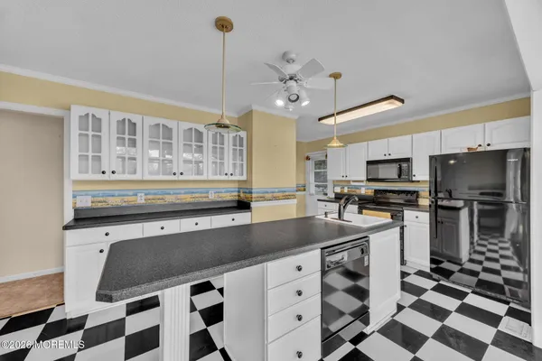 a kitchen with stainless steel appliances a sink a stove a refrigerator and cabinets